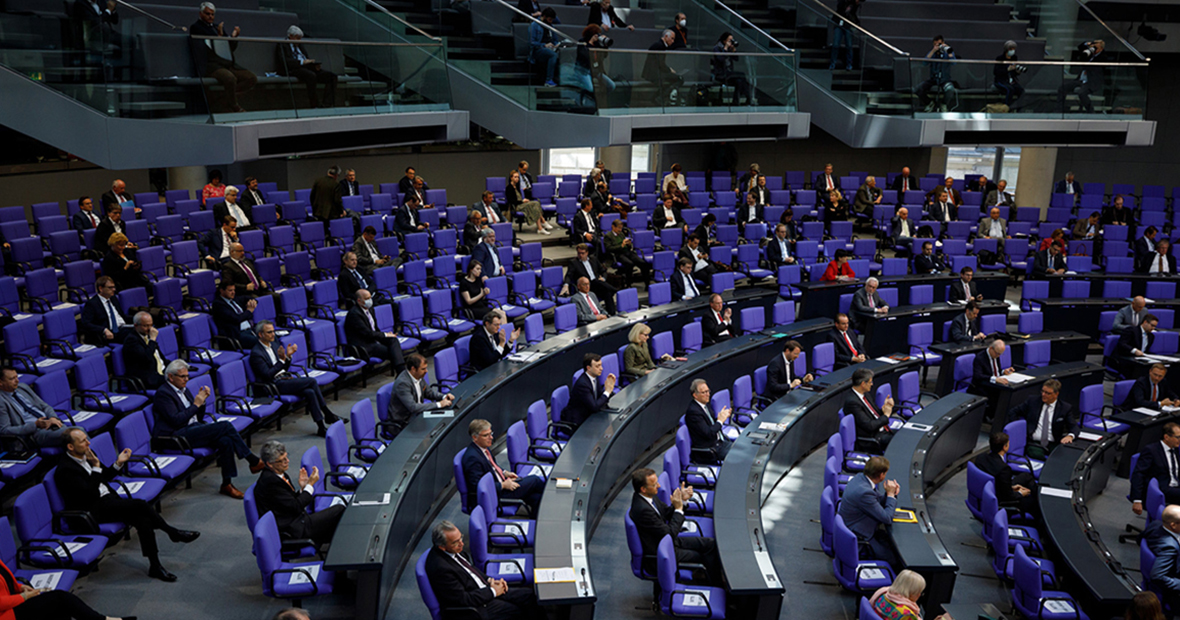 Mitglieder des Deutschen Bundestages sitzen im Abstand auf ihren Plätzen